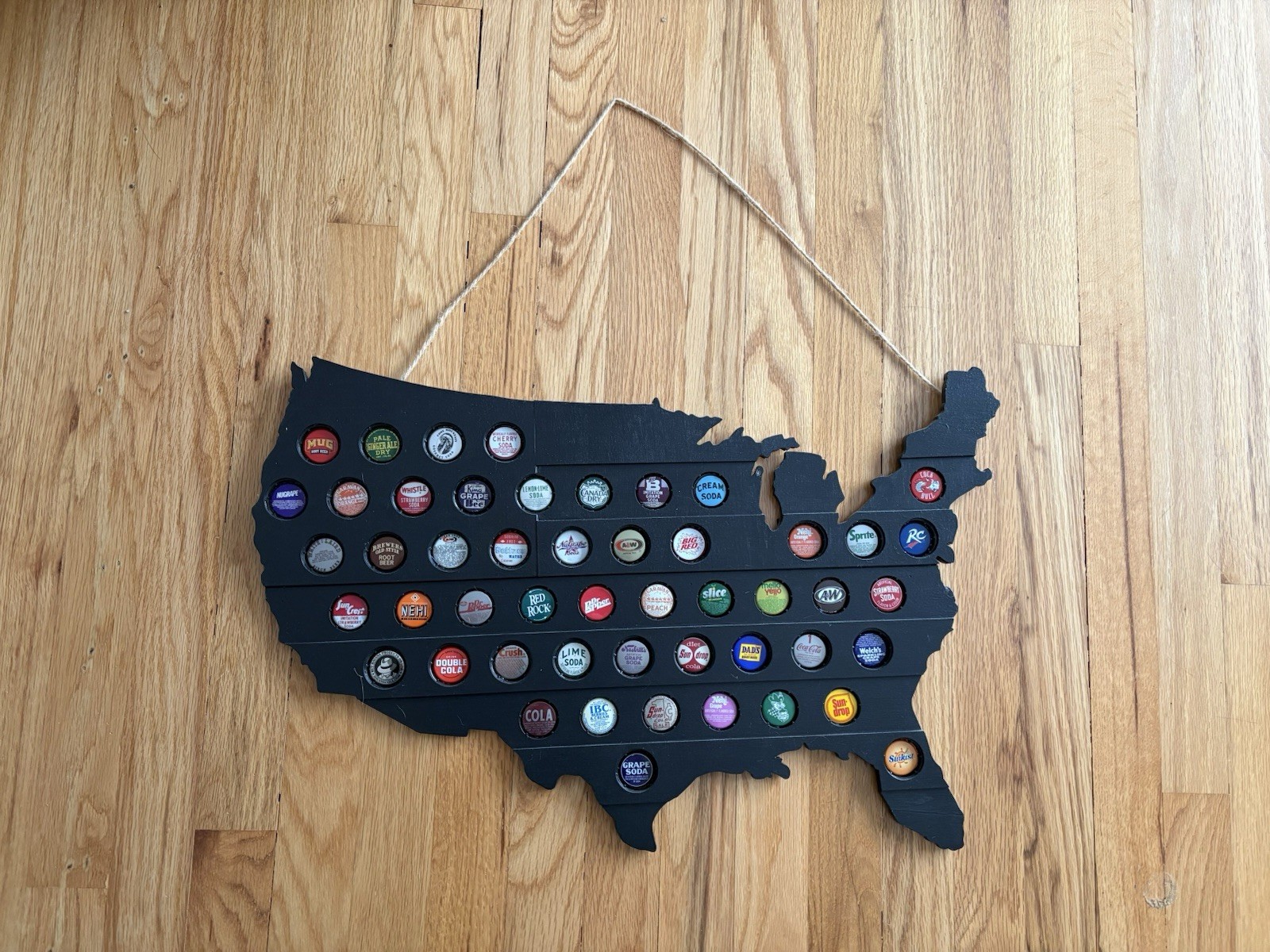 Black bottle cap soda map of United States hanging wall decor