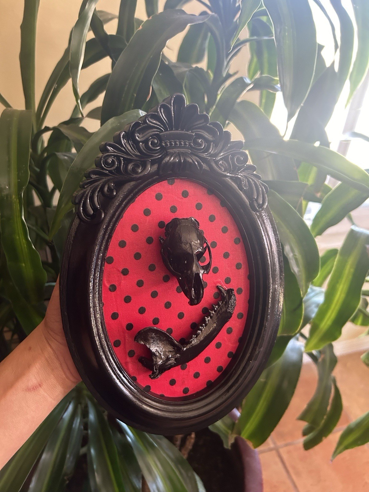 Gothic Oval Wall Plaque Black Framed Skull & Jawbone on Red Polka Dot Background